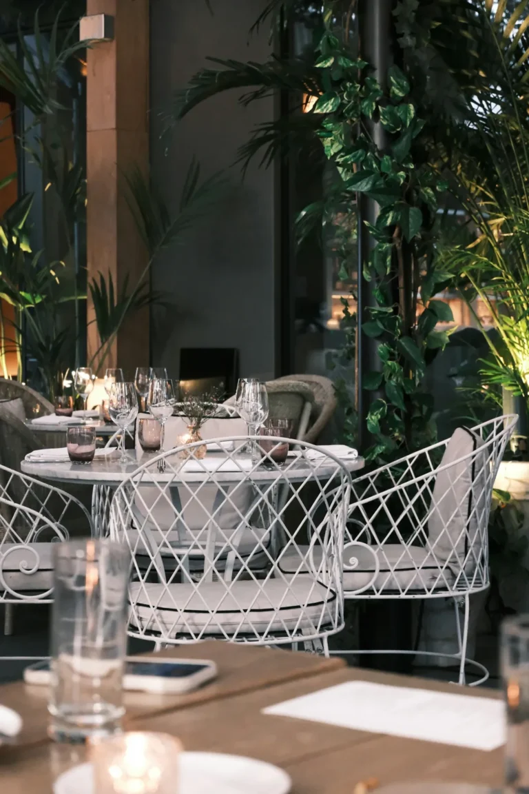 Garden room with white chairs and plants