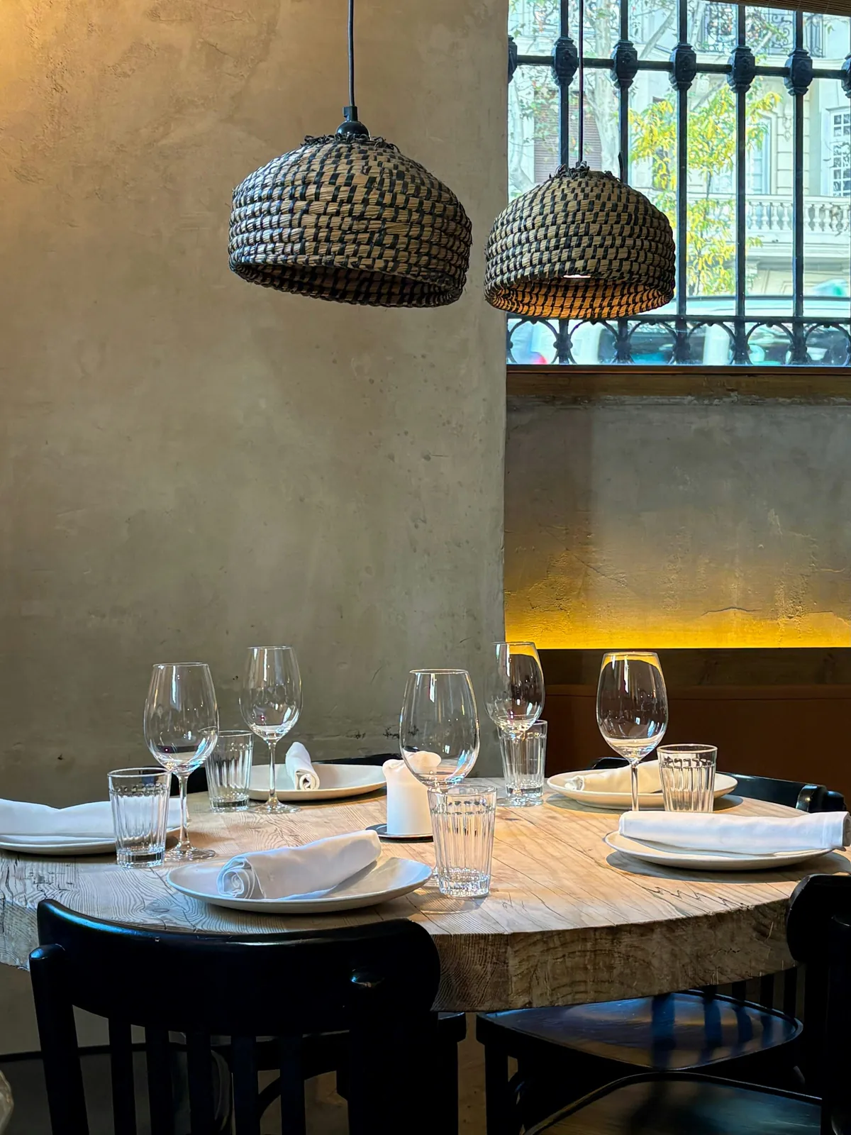 Dining room with woven lamps over a round table