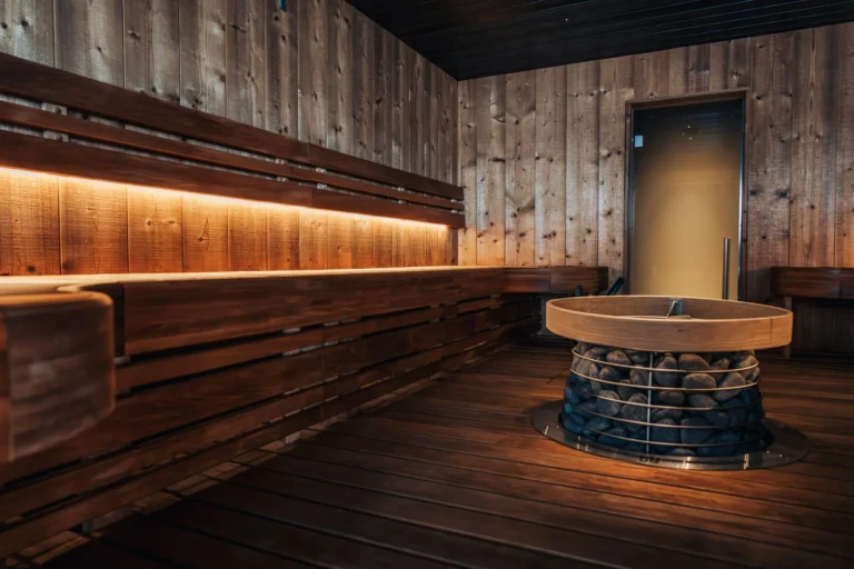 Large cedar sauna with a round stove