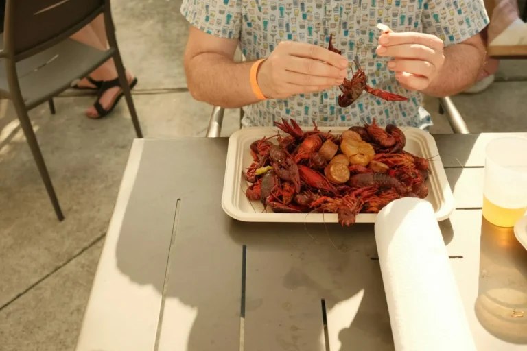 Guest peeling crawfish at the table