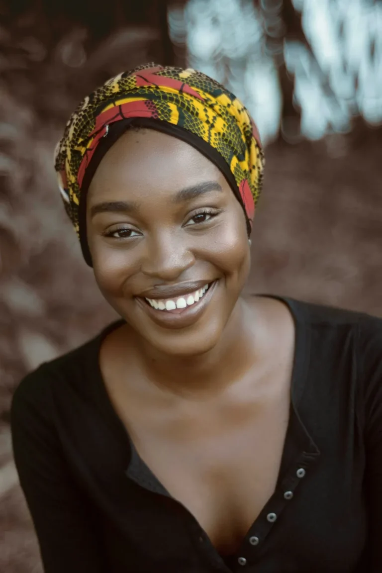 Smiling host in a headwrap
