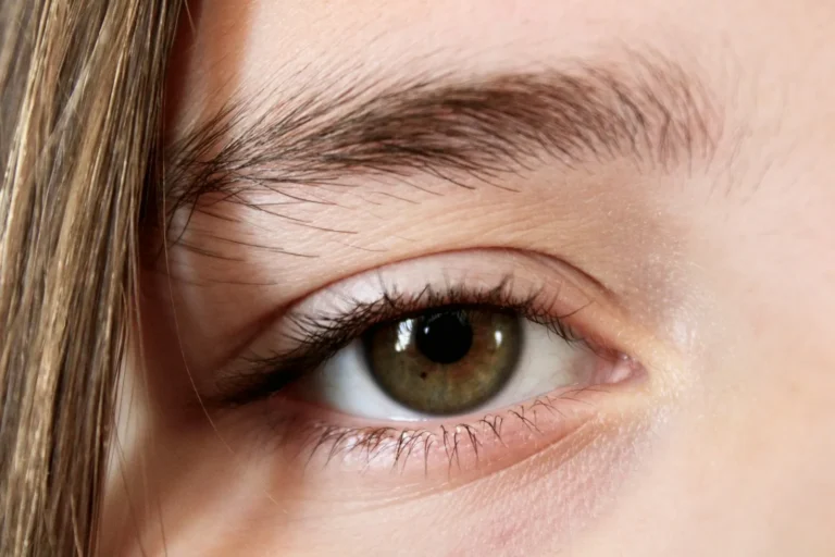 Soft natural brow over a hazel eye