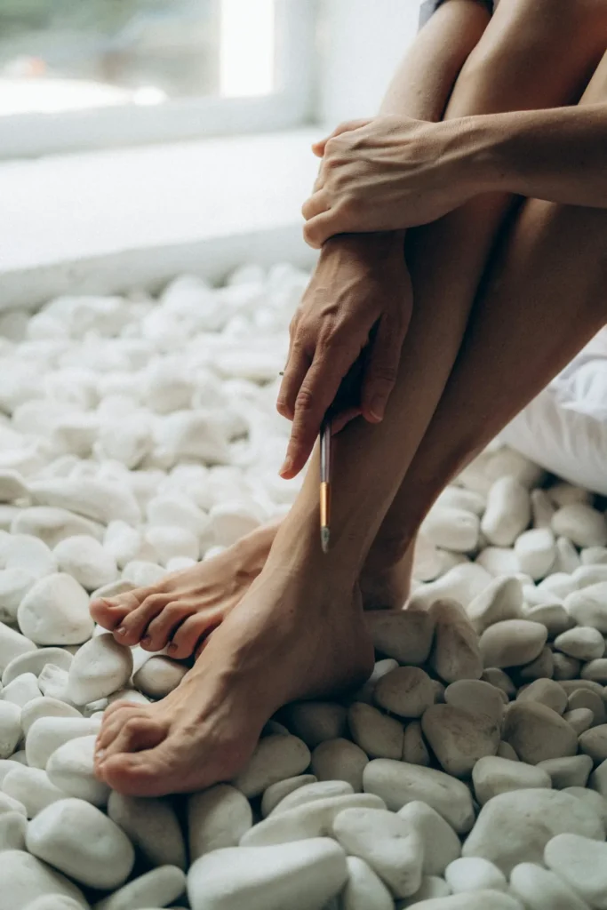Feet on white pebbles