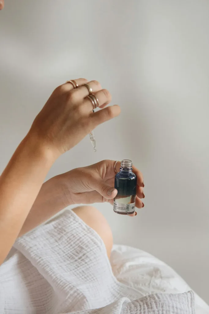 Hands holding a serum bottle