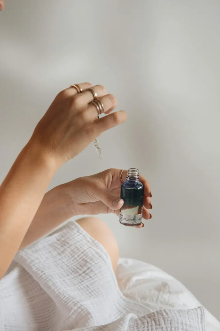 Hands holding a serum bottle