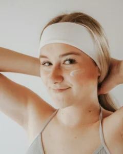 Smiling woman with dots of moisturizer