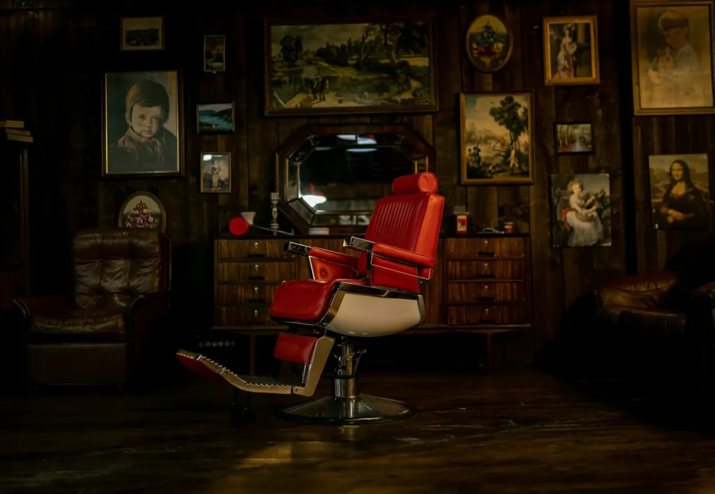 Red barber chair in a dark shop