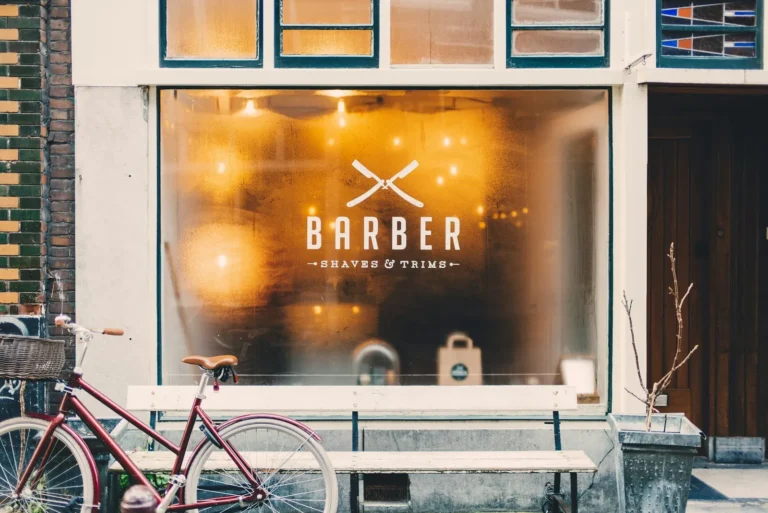 Barbershop window lit at dusk