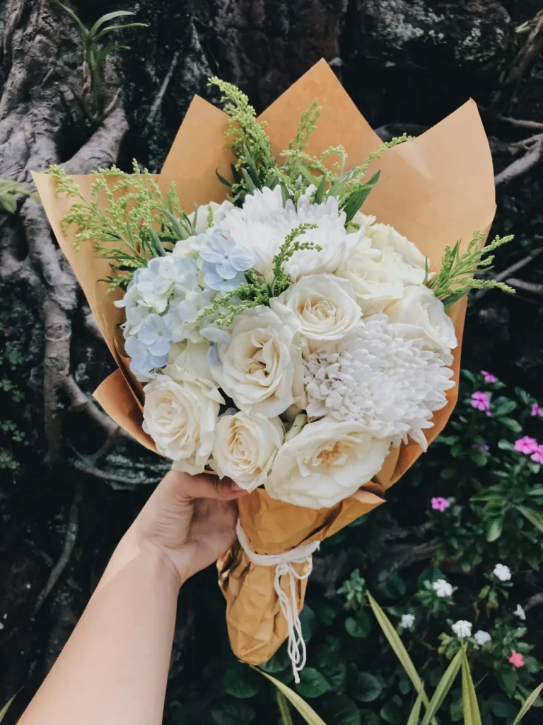 White roses wrapped in kraft paper