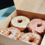 Box of glazed and strawberry donuts