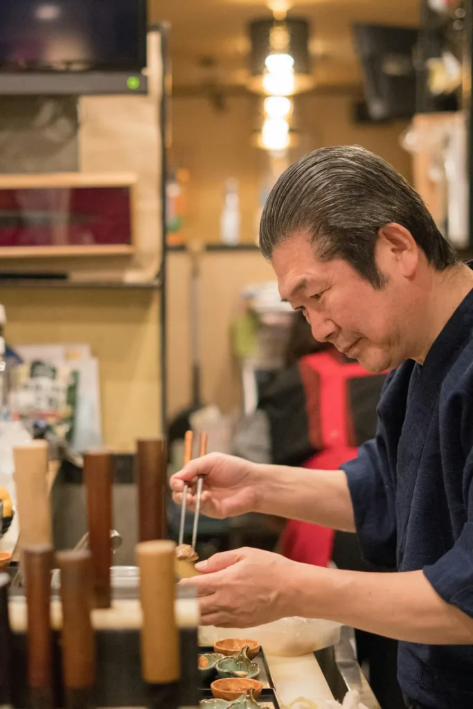 Sushi chef working at the counter