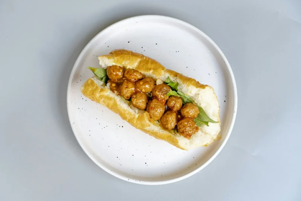 Meatball banh mi on a white plate