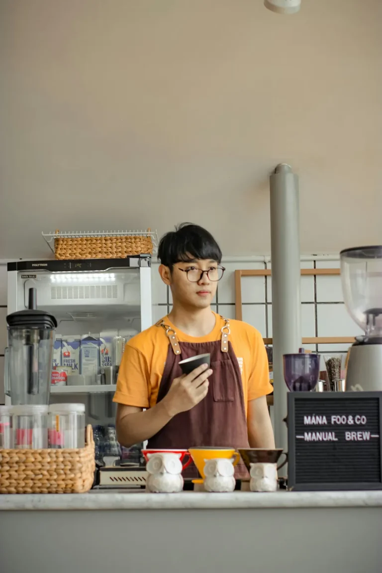 Crew member holding a coffee cup