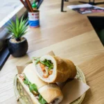 Banh mi in paper on a café table