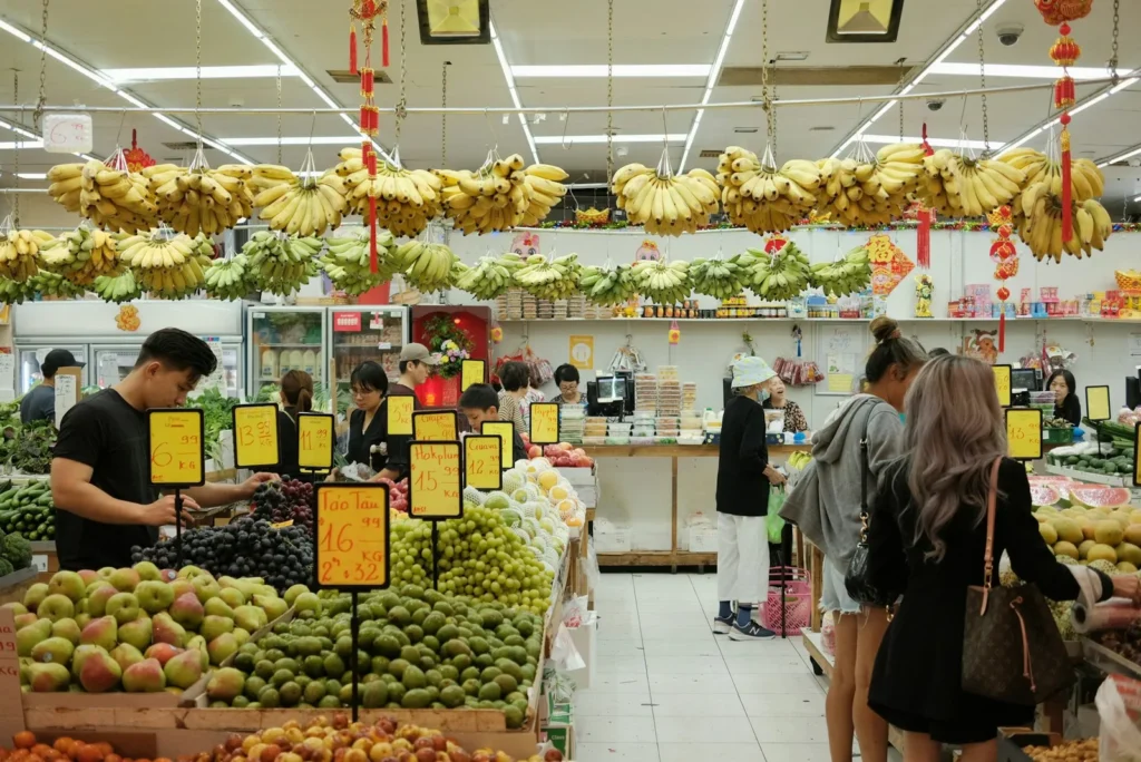 Produce aisle under red lanterns
