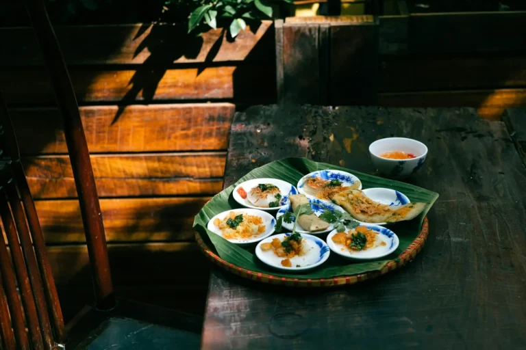 Steamed rice cakes in small dishes on a wooden table