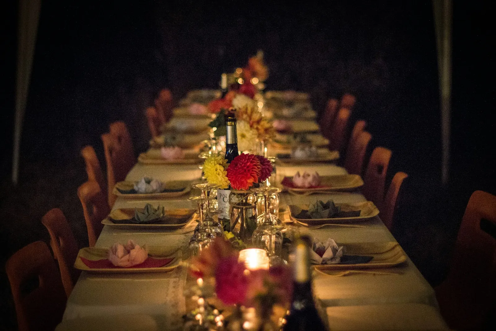 Long candlelit table set for a party