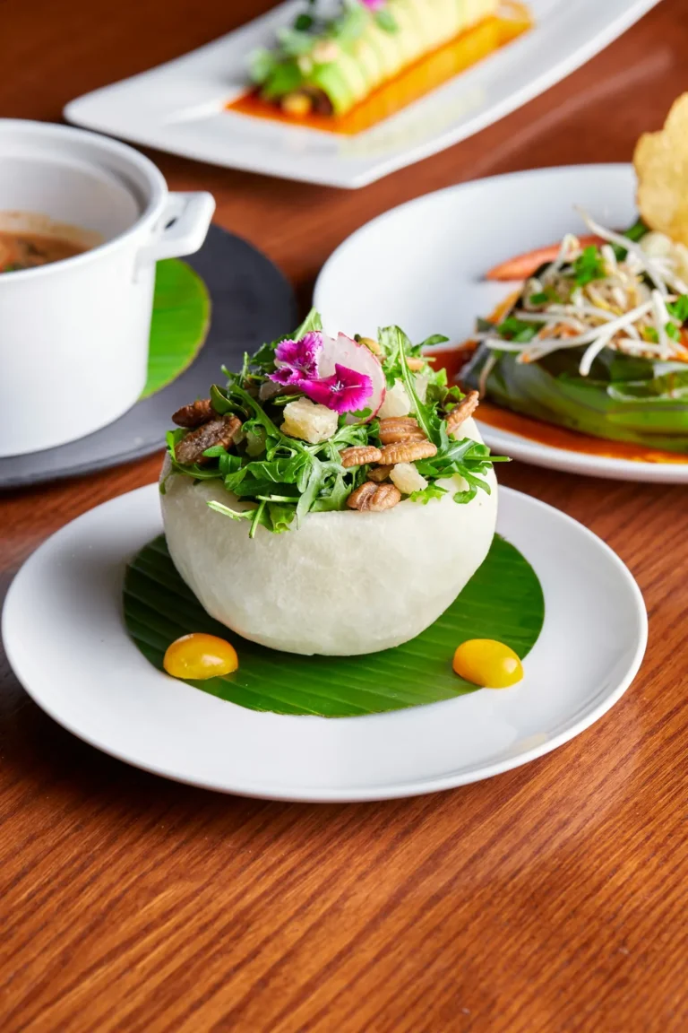 Herb salad with flowers served in a fruit bowl