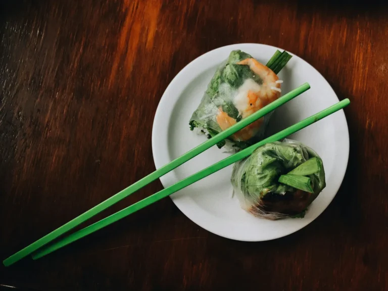 Summer rolls on a plate with green chopsticks