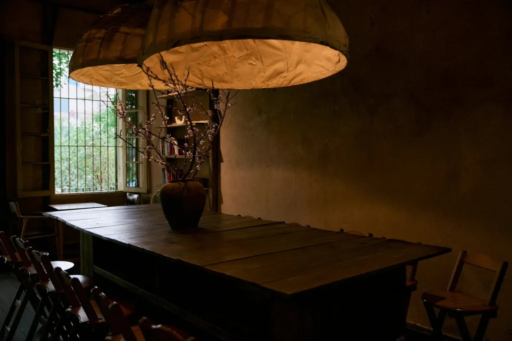 Long wooden table under paper lanterns
