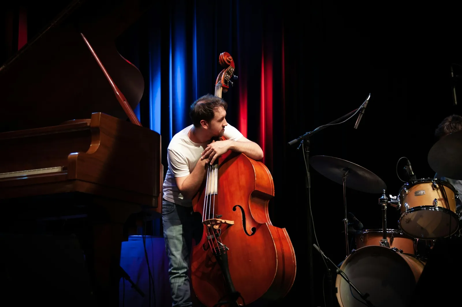 Bass player and piano on a small stage
