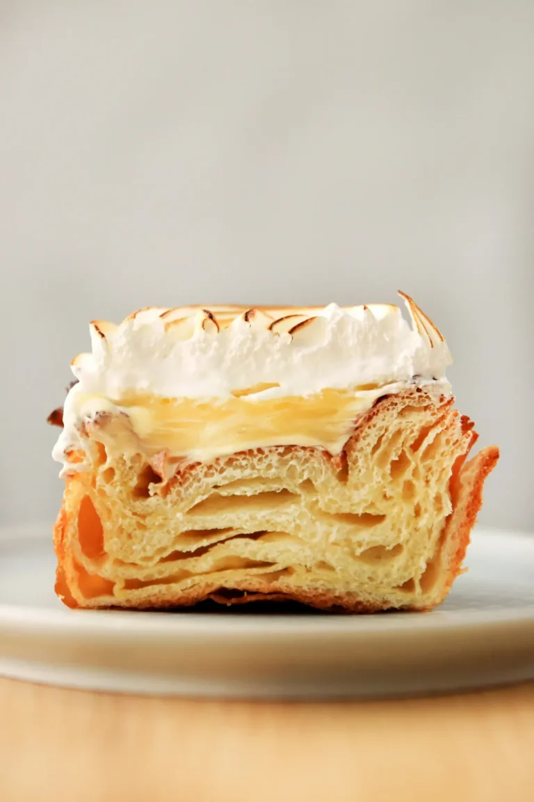 Lemon meringue tart cut to show the layers