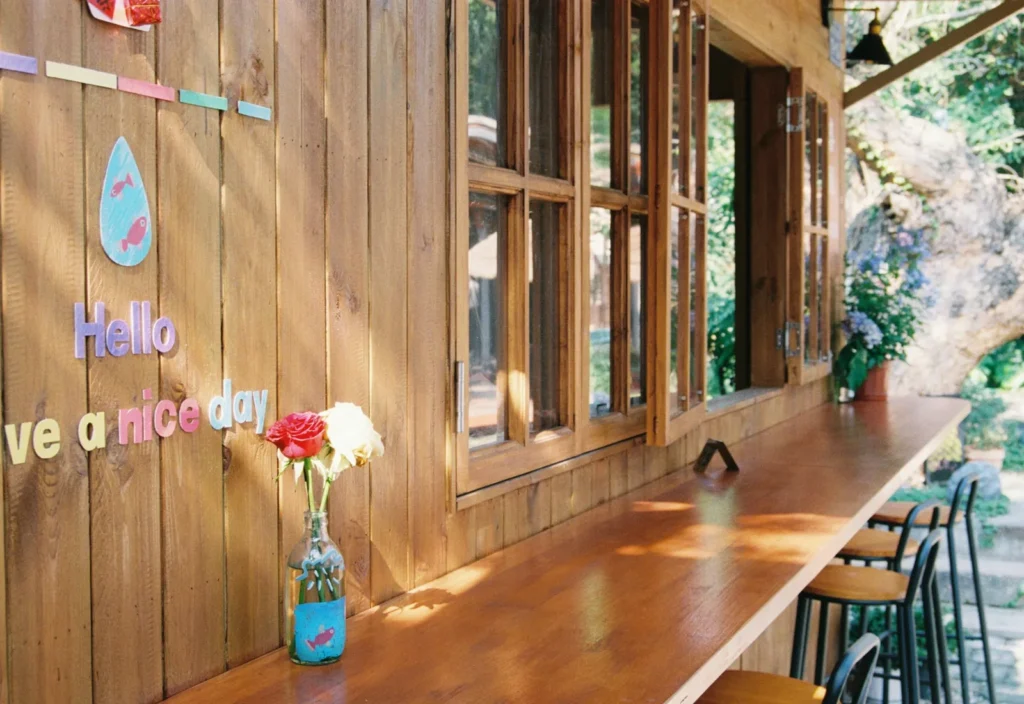 Sunny wooden counter with flowers