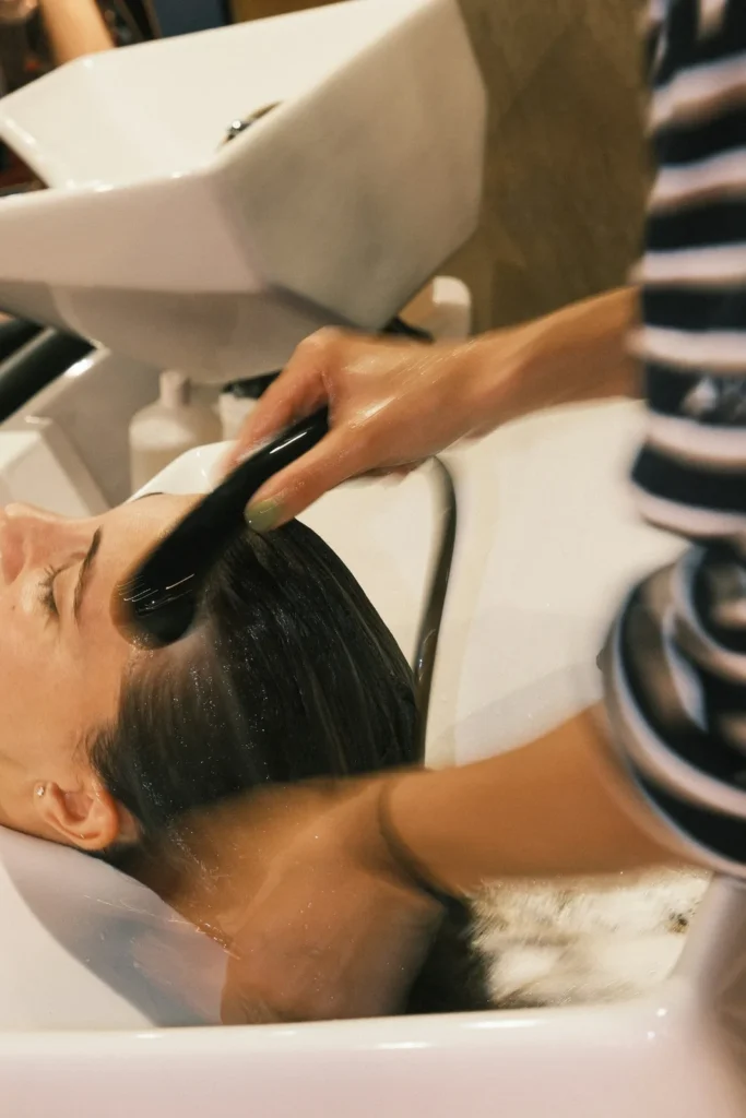 Hair being washed at a basin
