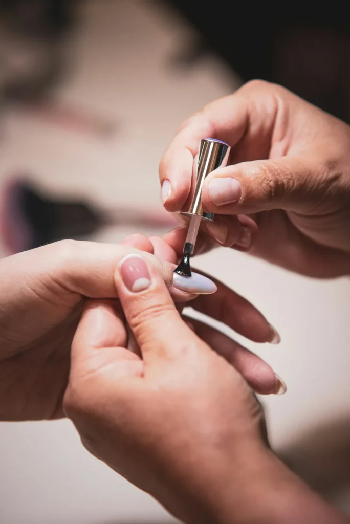 Nail technician applying polish