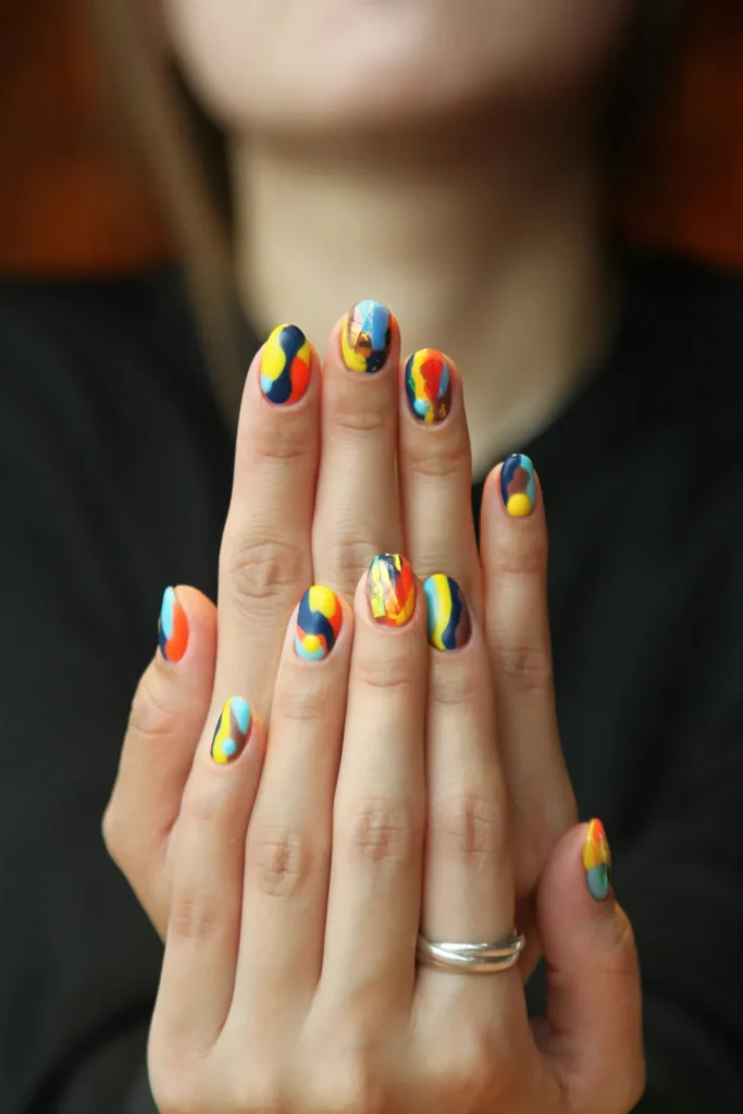 Hands with multicolor swirl nail art