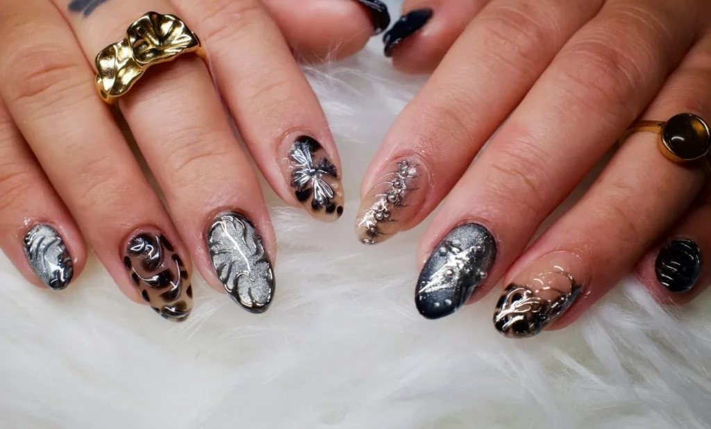 Black and silver nail art with gold rings