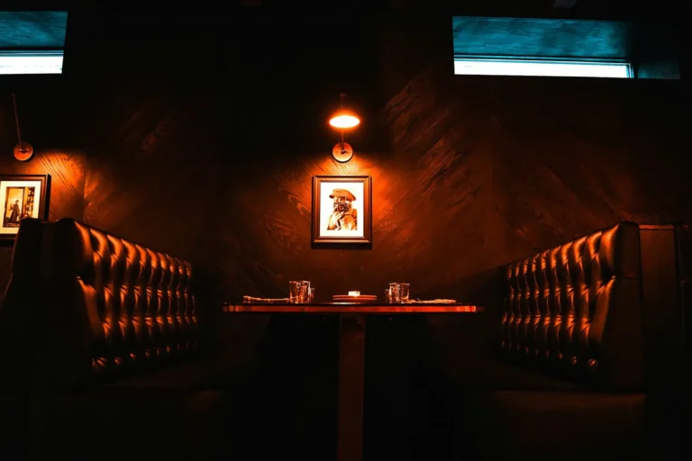 Red leather booths in a dark dining room