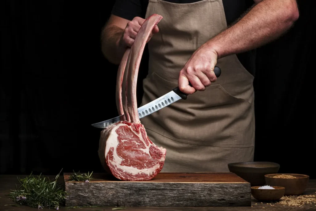 Butcher holding a tomahawk steak