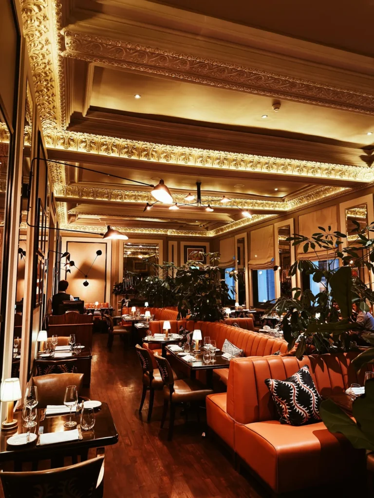 Dining room with a carved ceiling and leather booths