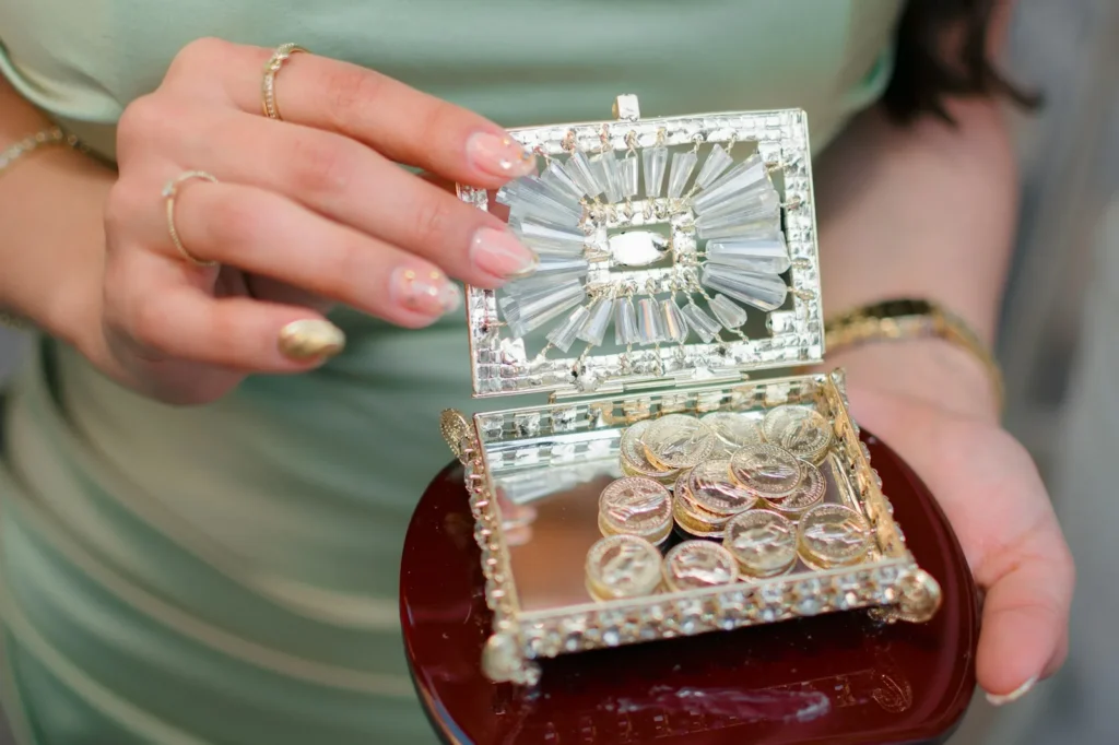 Soft nude manicure holding a crystal jewelry box