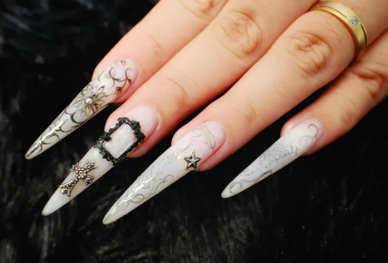 Pearl white stiletto nails with silver chrome art