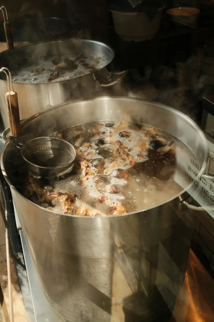 Stock pot of beef broth simmering in the kitchen