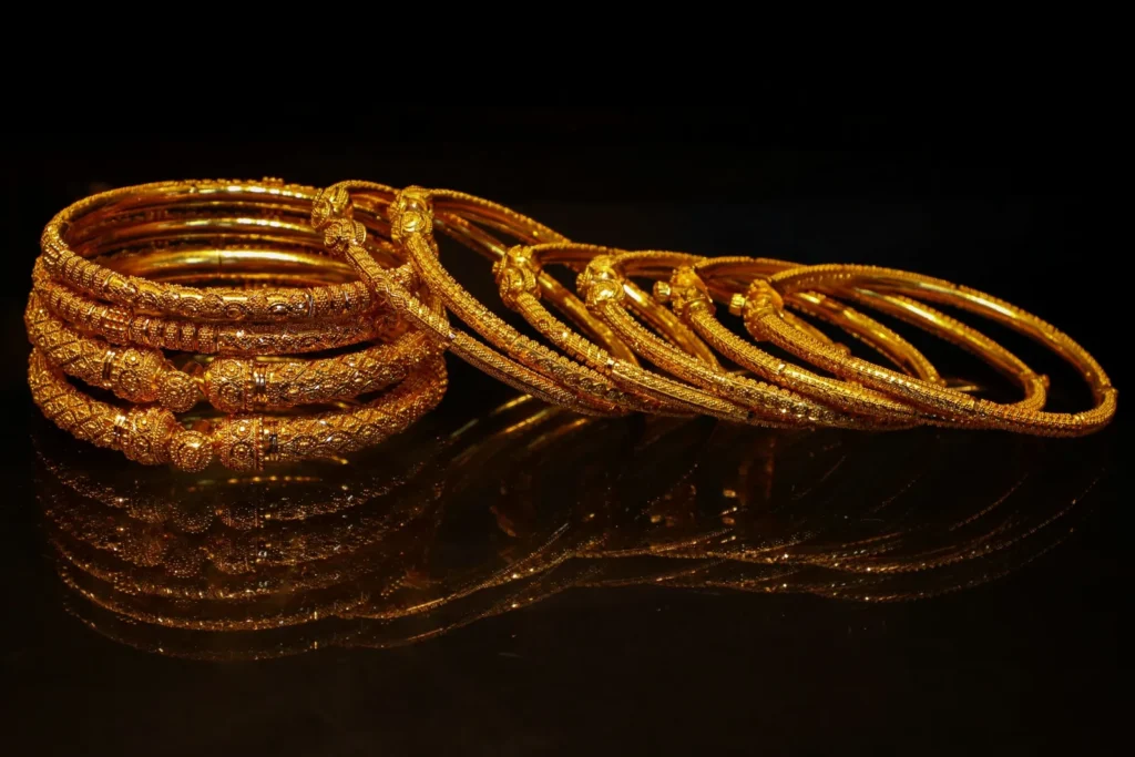 Gold bangles stacked on black