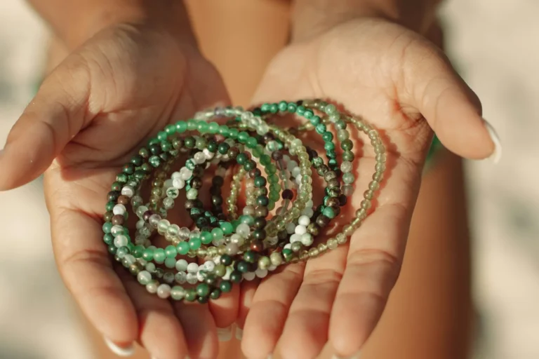 Hands holding jade bead bracelets