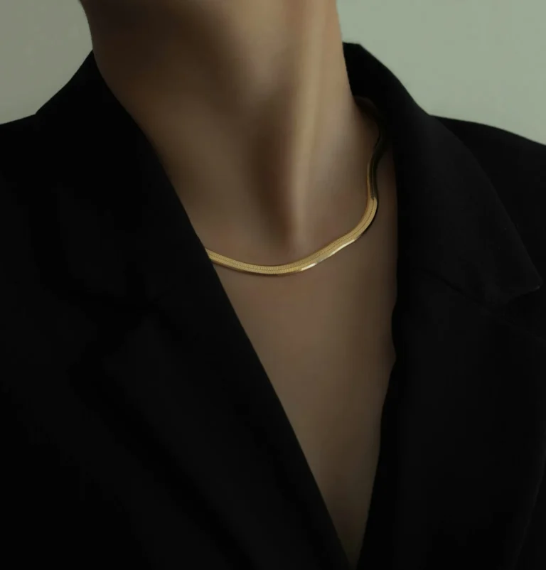 Herringbone gold chain on a black blazer