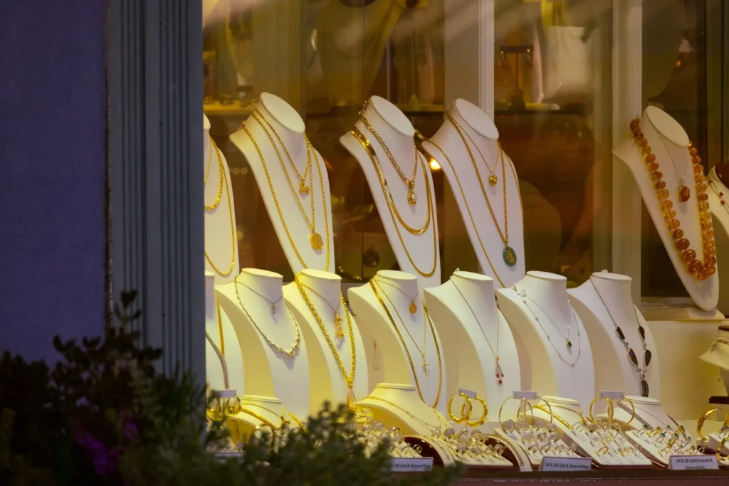 Gold necklaces in a lit shop window