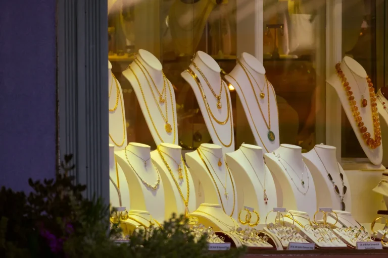 Gold necklaces in a lit shop window