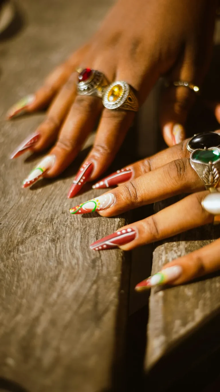 Long painted nails with gold rings