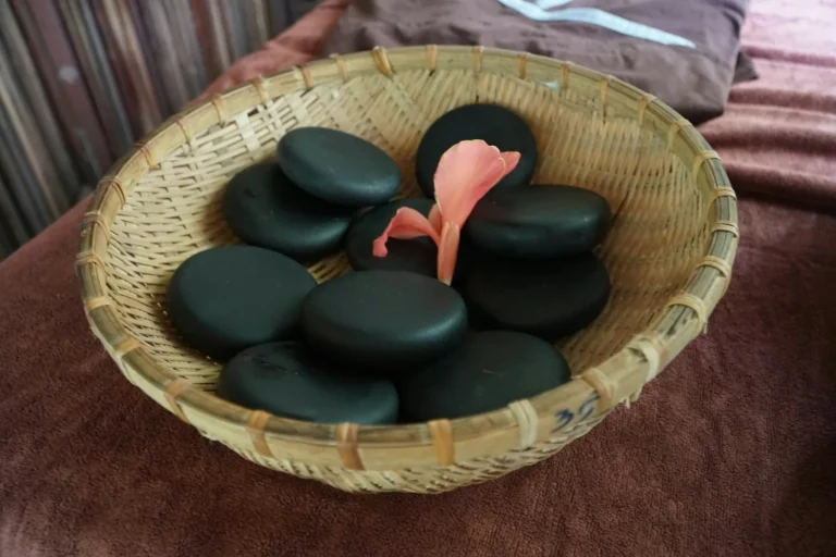 Basket of massage stones with a petal