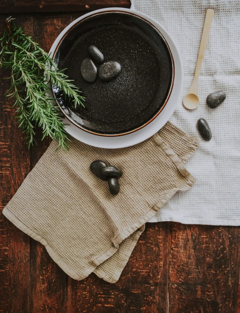 Stones in a bowl with rosemary and linen