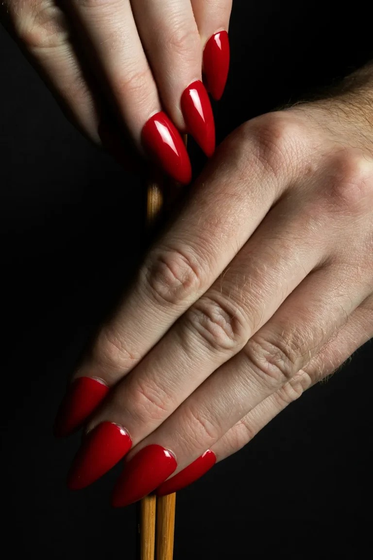 Long red almond nails on black