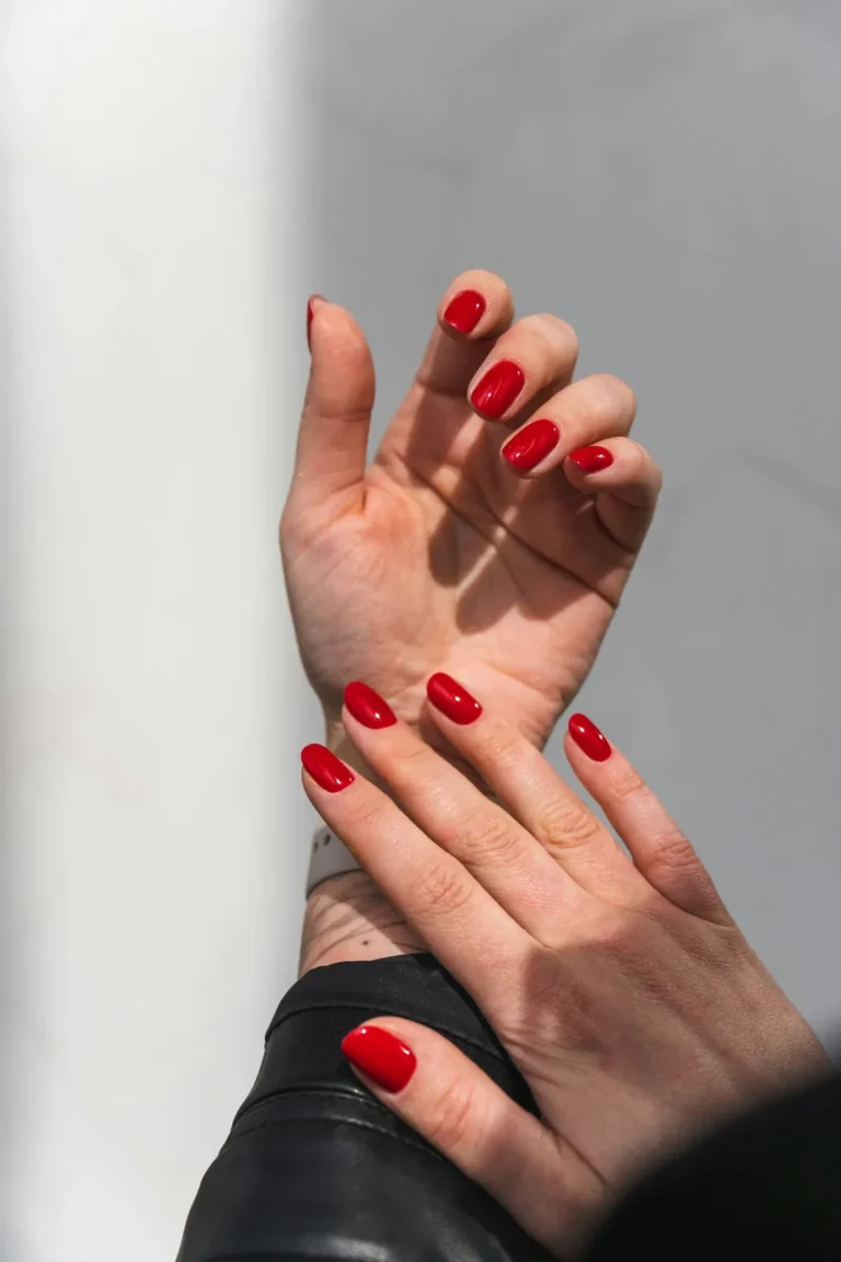 Two hands with red nails