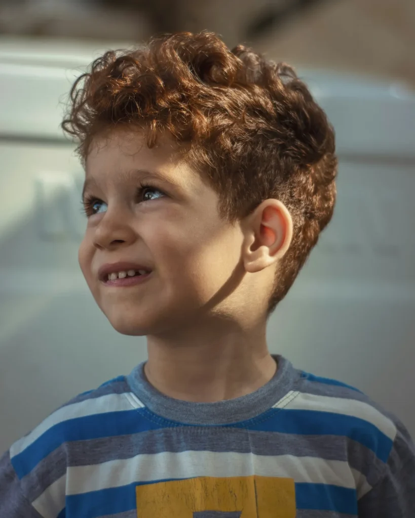 Smiling boy with curly hair