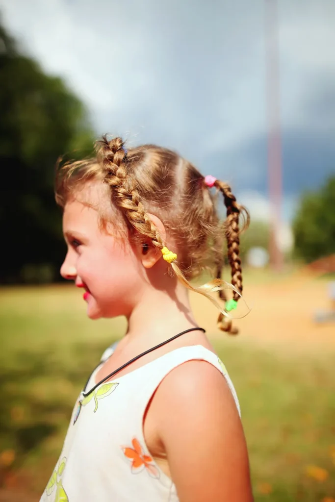 Girl with braids and colorful ties