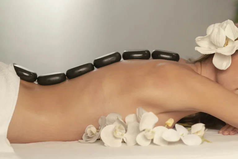 Hot stones along the back with white orchids
